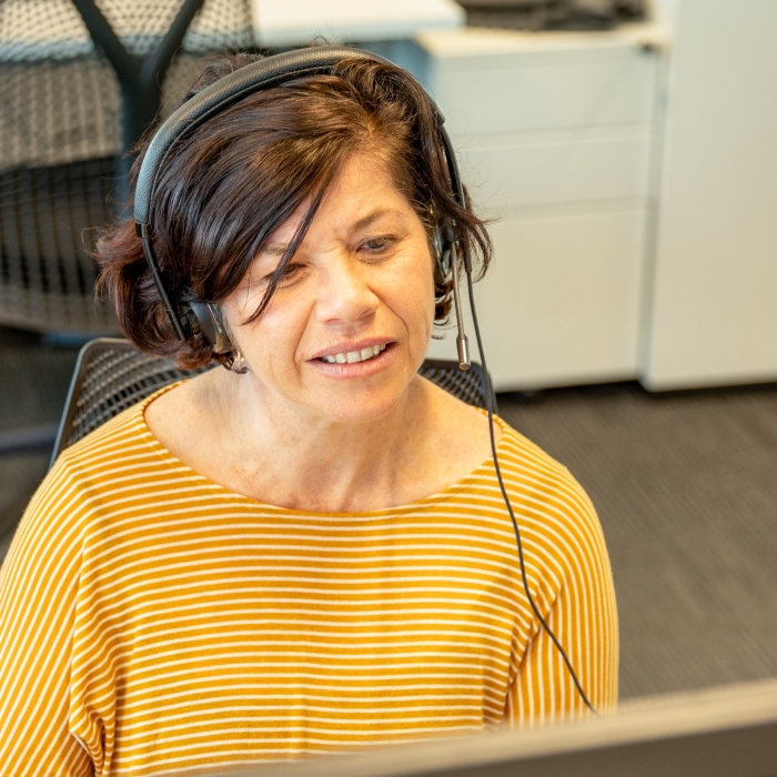 Crisis supporter wearing a headset and microphone, attentively providing support