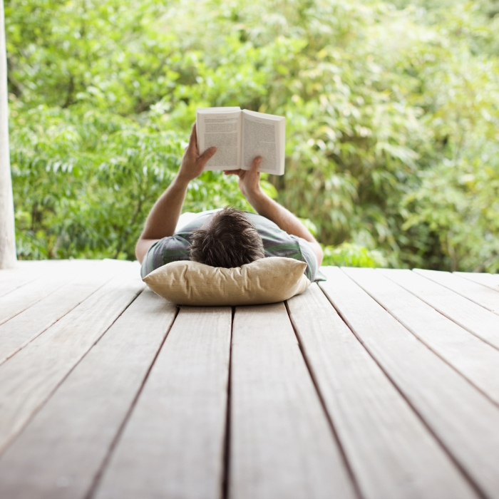 Man reading a book in a relaxed setting