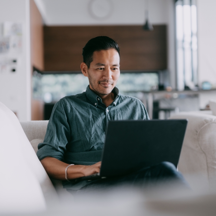 Man sitting on laptop in relaxed setting