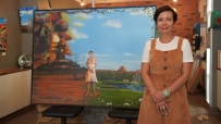 woman standing in front of artwork