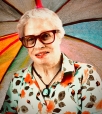 portrait of woman wearing glasses and floral shirt