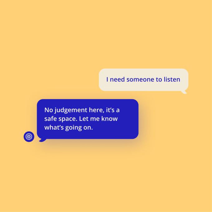 A digital chat interface on a soft yellow background shows a conversation. A white chat bubble on the right, from a user, states 'I need someone to listen'. Below it, a blue chat bubble on the left, from a support service and marked with a small white icon, replies 'No judgement here, it's a safe space. Let me know what's going on.'