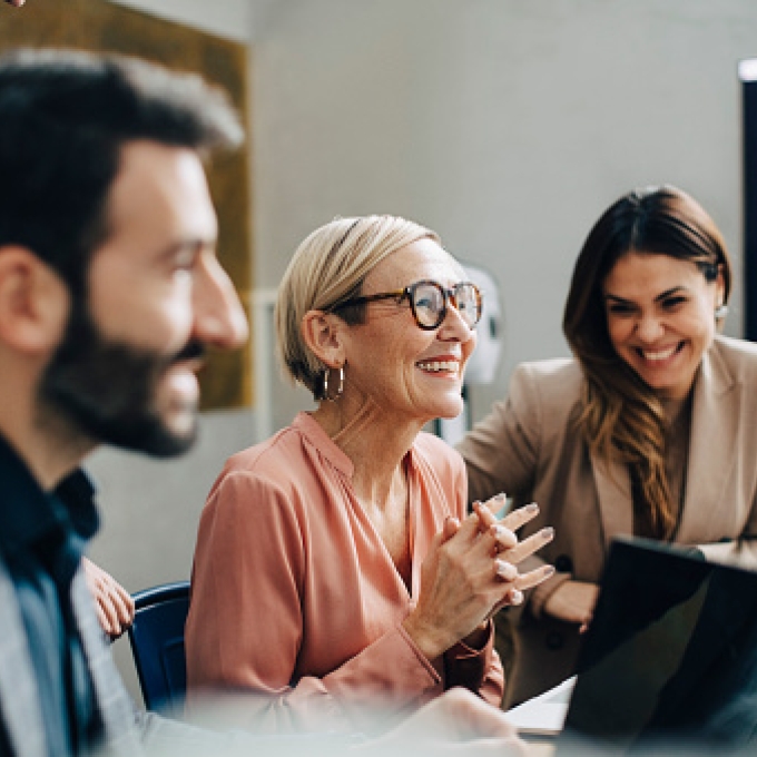 Three office workers in front of a computer