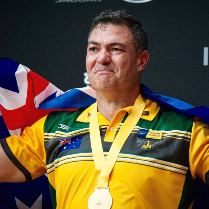 sportsman wearing medal and australian flag 