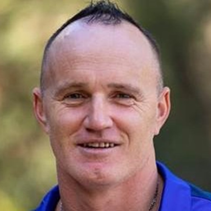 smiling man with blue shirt