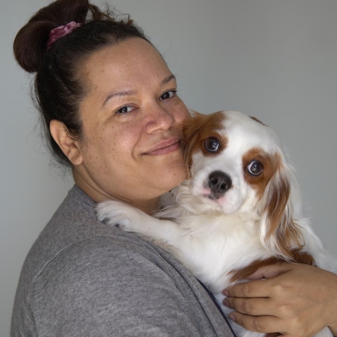 woman holding a small dog
