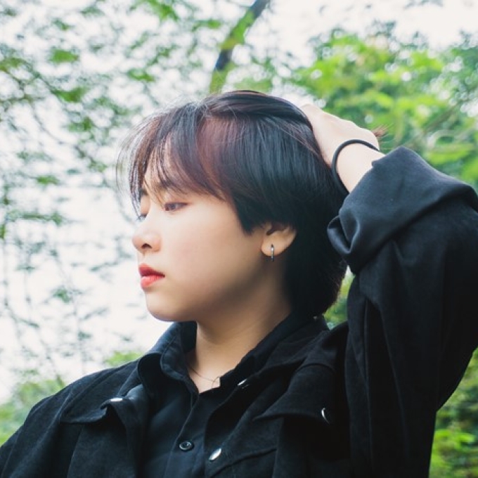 person outside touching their hair