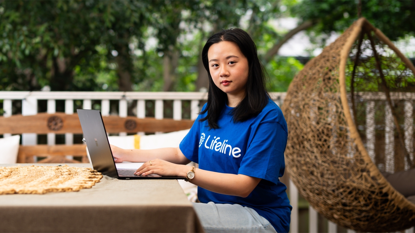 Crisis supporter sitting on terrace looking at camera